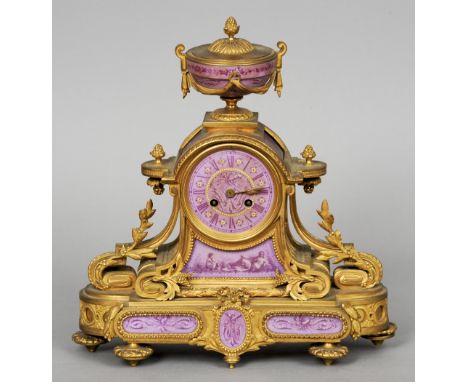 A 19th century porcelain mounted ormolu mantel clock
The urn form finial above the enamel beaded porcelain dial with Roman nu