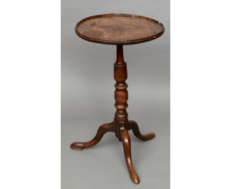 An 18th century burr elm topped tripod table
The dished circular top above the turned elm column, standing on three outswept 