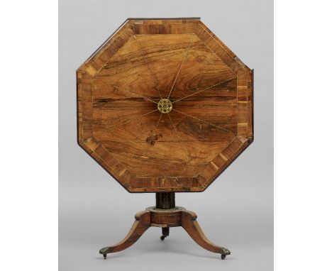 A Regency brass inlaid rosewood tripod table
The octagonal top with brass stringing centred with a pierced brass roundel, sta