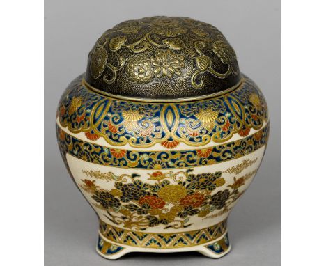 A late 19th century Satsuma jar and cover
The metal cover with floral decoration, the underside signed.  14 cm high. CONDITIO