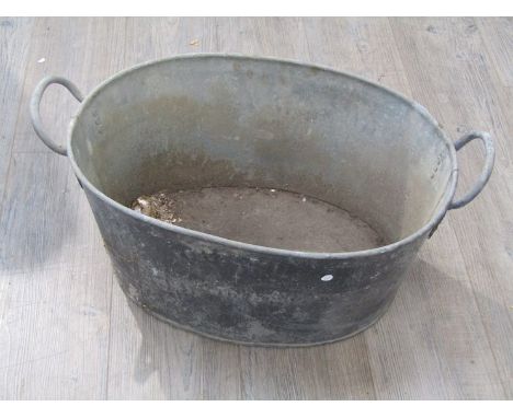 A 1951 dated galvanised wash tub with broad arrow mark 