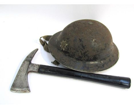 A WWII Ipswich fire service helmet together with a fireman's axe 