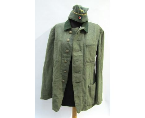 A WWII German Army soldier's service jacket reputedly used by a German POW with pockets added, stamped 