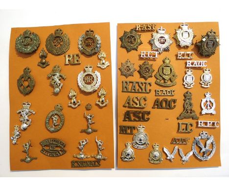 Two boards of military badges and shoulder titles including Royal Corps of Signals and Royal Army Ordnance Corps