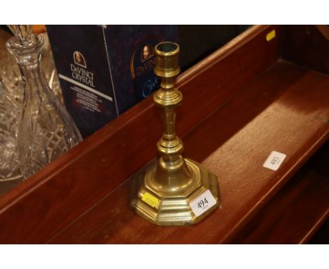 An 18th Century single brass candlestick 