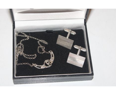 A pair of silver cuff-links and a pendant hung to a fine link chain 