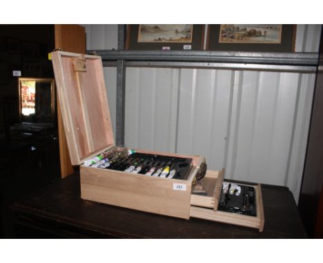 An artists travelling paint box and easel 