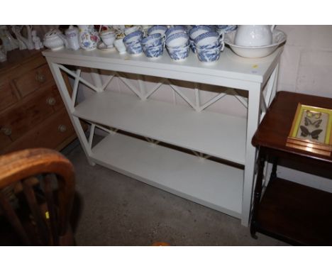 A painted three tier wall shelf 