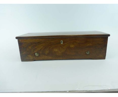 A 19th century Swiss cylinder music box, playing on eight airs, bearing a paper label for Fabrique de Geneve, within a rosewo