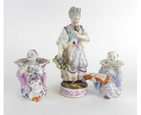 A near pair of Meissen containers each modelled as a seated figure wearing a ruff, max h. 8.5 cm, together with an 18th centu