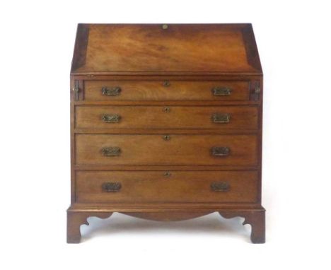 A late 18th/early 19th century mahogany bureau, the fall front enclosing a fitted interior over four long graduated legs on b