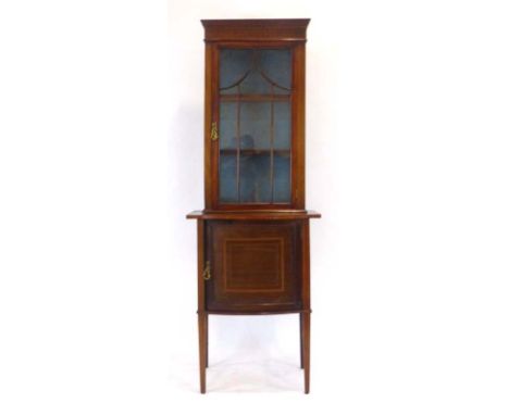 A late 19th/early 20th century mahogany, walnut, strung and crossbanded cabinet, the glazed door enclosing two shelves over a