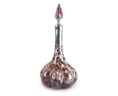 An Edwardian silver overlaid cranberry glass decanter and stopper, Birmingham 1907, h. 30 cm (af) CONDITION REPORT: Glass ver