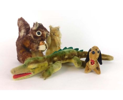 A Steiff stuffed animal modelled as a squirrel, button to ear, together with a similar squirrel, larger, a crocodile and a sa