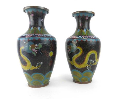 A pair of cloisonne vases of baluster form decorated with a pair of dragons on a famille noir ground, h. 26.5 cm CONDITION RE