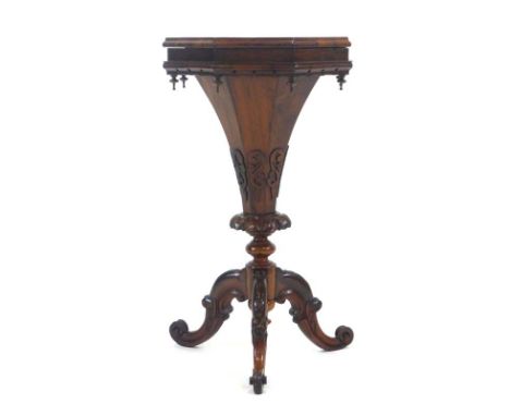 A William IV rosewood octagonal sewing table of trumpet form, the base with blind fretwork and turned finials over tripod and