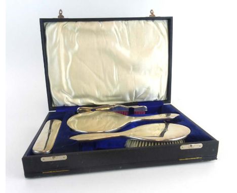 A cased set containing a four piece silver backed dressing table set, Chester 1921 CONDITION REPORT: Typical dents and wear. 