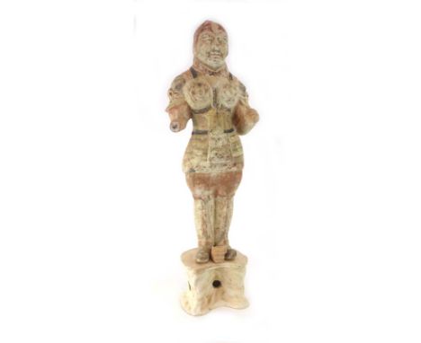 A Tang Dynasty painted pottery figure modelled as a guard in full armour on a rockwood base, h. 68.5 cm*see Lot 190 Sotheby's