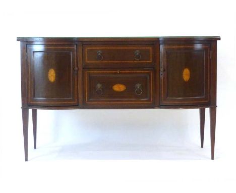 An Edwardian mahogany, strung and crossbanded sideboard, the two bow fronted doors flanking a pair of drawers, on square tape