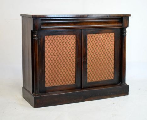 Mid 19th Century rosewood side cabinet, with cushion-moulded drawer over brass lattice doors enclosing shelf between turned c