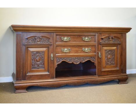 Edwardian carved mahogany sideboard fitted two drawers and recess between pedimented cupboards enclosing shelves and bottle c