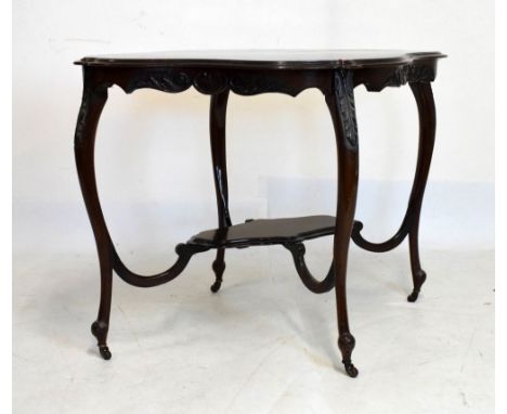 Edwardian carved mahogany occasional table of cartouche form on four leaf-carved cabriole supports, swivel casters and under 