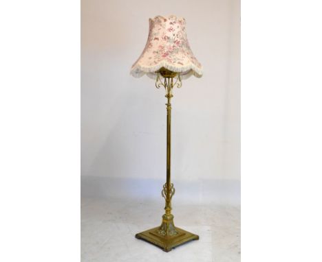 Early 20th Century brass adjustable standard lamp with brass reservoir and octagonal stem on spreading square base, 149cm hig