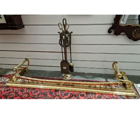 Brass fire curb&nbsp;with raised support to the front and twin handles, 134cm long approx. and a set of fireside tools&nbsp;(