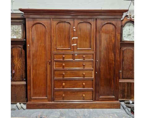 19th century mahogany compactum with stepped ogee and cavetto cornice, central linen cupboard, an arrangement of two short an