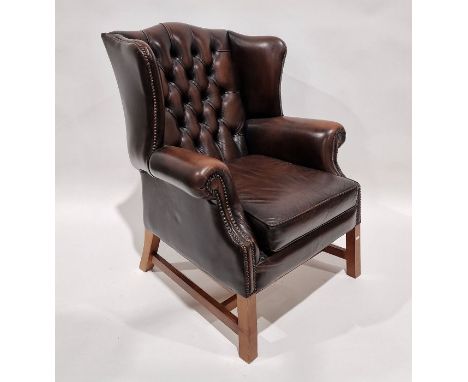 Pair of brown leatherette button upholstered Georgian-style armchairs with outscroll arms, straight square supports and H-str
