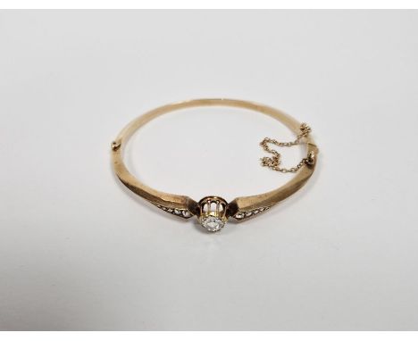 Gold and diamond set bangle, the central old cut diamond 6mm diameter approx., flanked by five graduating diamonds to either 