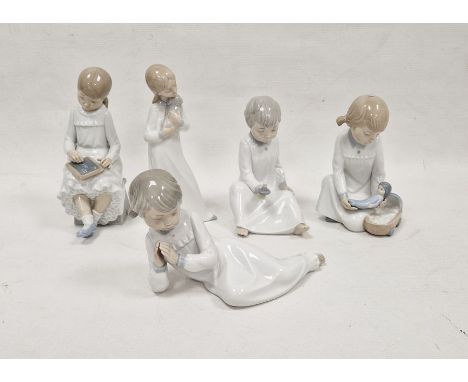 Five Nao figures of children, 20th century printed brown marks incised symbols and numerals, each dressed in white nightwear,