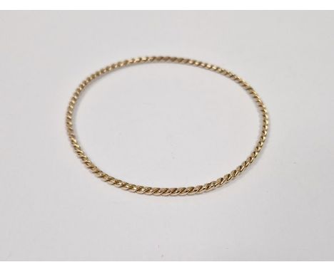 Twisted gold-coloured metal bangle, 6.5g approx. Condition ReportThis bangle tests as 9ct gold or higherDiameter approx. 7cm