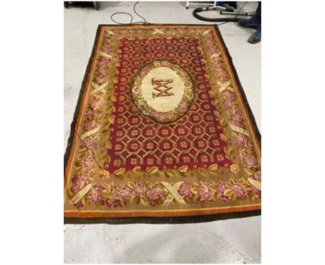Large Aubusson red ground rug with central M motif on oval medallion over geometric field, single floral border 257cm x 160cm