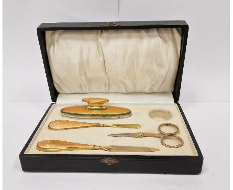Gilt-coloured metal and orange enamel manicure set in fitted box 