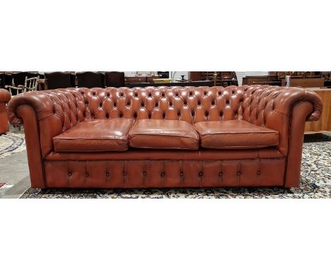 Brown leatherette Chesterfield three-seater sofaCondition ReportLight surface scratches and marks, some scuffs. Wear and craz