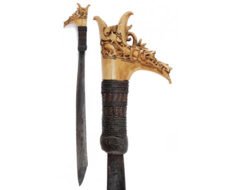 dating: circa 1900 provenance: Kalimantan, Strong, single-edged blade. Bone grip, richly embossed, base covered with vegetabl