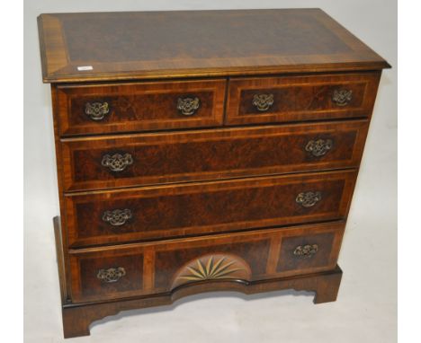 An American burr walnut chest of 2 short and 3 long drawers, with marquetry decorated sunburst to the bottom drawer, raised o