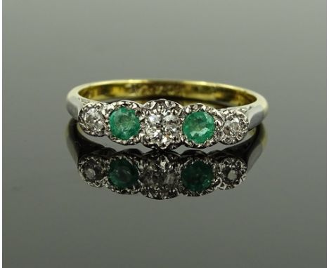 A 5 stone emerald and diamond ring, 18ct gold and platinum settings, size R.