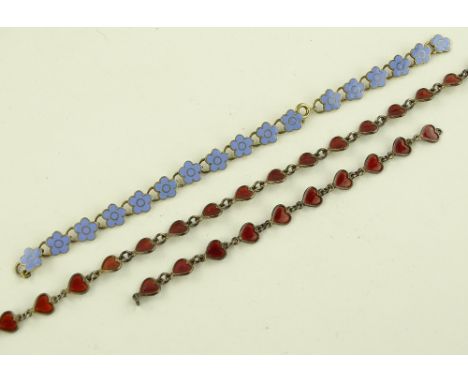 A silver and red enamel heart design necklace and matching bracelet, and a blue enamel and silver bracelet.