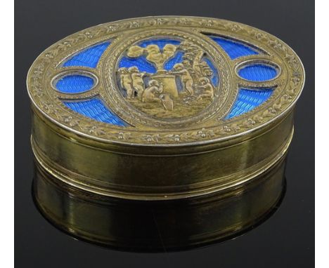 An ornate French oval silver gilt and blue enamel box, cast lid with cherub designs, continental marks, length 8cm.