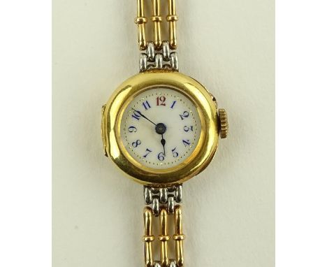A lady's Swiss 18ct gold cased fob wristwatch, gilded and enamelled dial with 15ct gold strap, movement stamped R & C, case n