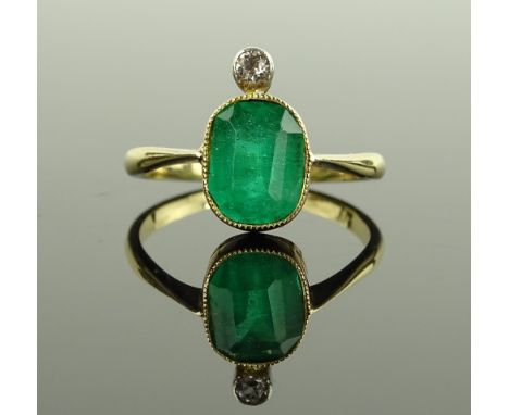 A 9ct gold synthetic emerald and diamond set ring, setting height 15mm, size R.