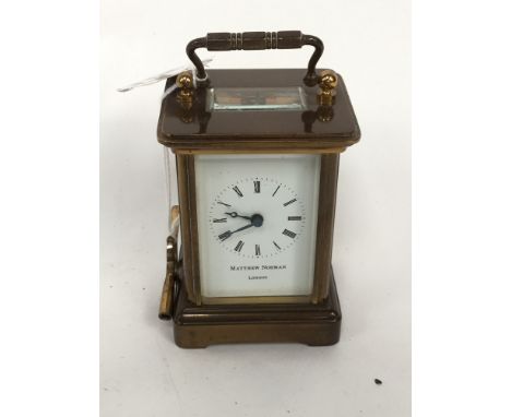 A miniature brass carriage clock with Roman numerals to dial, Matthew Norman, London, with key (1)