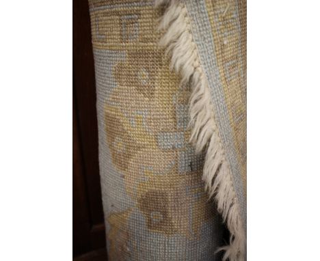 Ex Luddington Manor****A Persian style light turquoise and beige woollen rug, medium sized