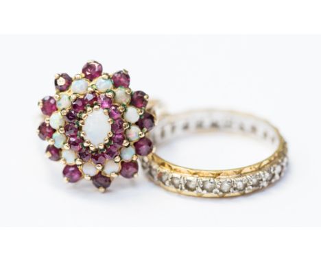 A 9ct gold, opal and garnet large cluster ring, size N, along with a yellow and white metal ring fully set with white stones,