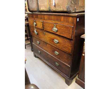 A George III oak chest of drawers, circa 1780, fitted with two short over three long graduated drawers, raised on bracket fee