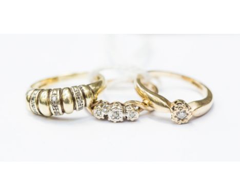  Three diamond set 9ct gold rings to include a three stone ring with twist shoulders, size N,  an illusion set solitaire, siz