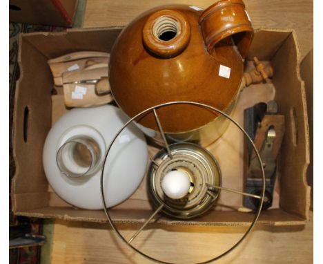 A cast metal 'record' plane; together with a brass oil lamp converted to electricity, a pair of shoe lasts and a large cider 