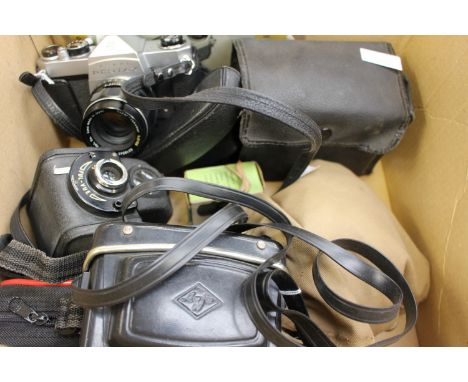 A 1970's Asahi Pentax camera with instructions and other cameras
